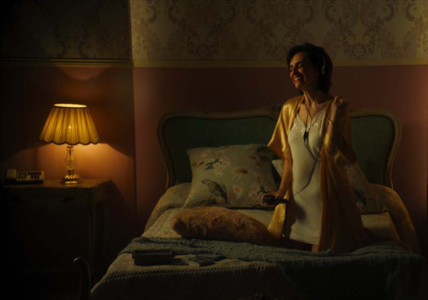 A woman sitting on a bed